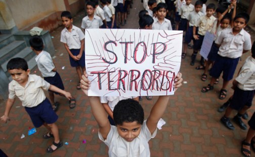 A student lifts a placard as he and others line up to take part in a march for peace in Mumbai